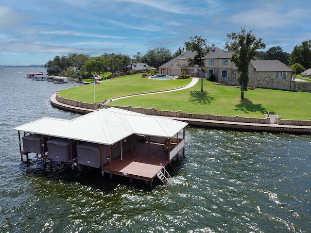 view of dock featuring a lawn and a water view