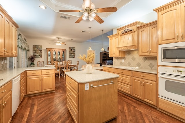 kitchen featuring kitchen peninsula, decorative backsplash, dark hardwood / wood-style flooring, white appliances, and decorative light fixtures