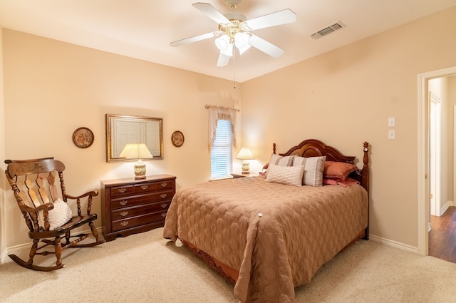 bedroom with ceiling fan and light colored carpet