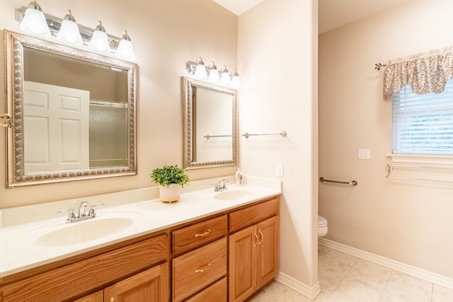 bathroom with tile patterned flooring, vanity, an enclosed shower, and toilet