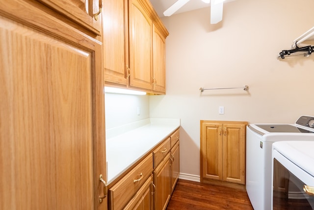 clothes washing area with washer and dryer, dark hardwood / wood-style floors, ceiling fan, and cabinets