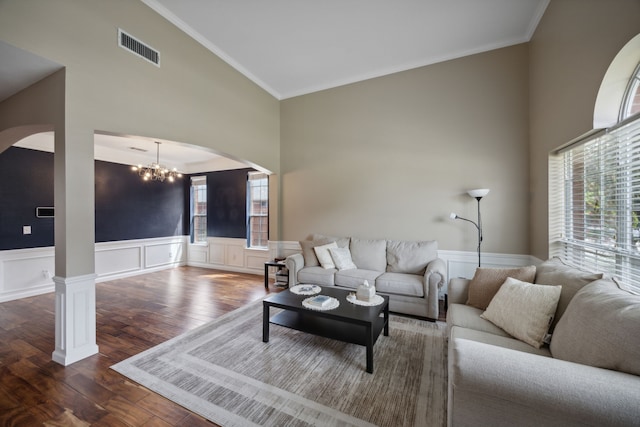 living room featuring dark hardwood / wood-style floors, a chandelier, high vaulted ceiling, and a healthy amount of sunlight