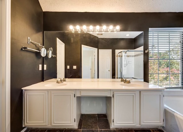 bathroom featuring a textured ceiling, tile patterned flooring, vanity, and plus walk in shower