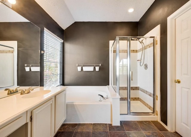 bathroom with plus walk in shower, lofted ceiling, and vanity