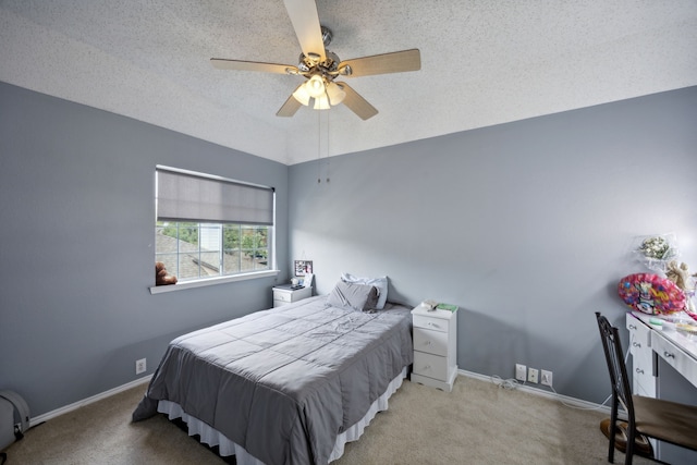 carpeted bedroom with ceiling fan and a textured ceiling