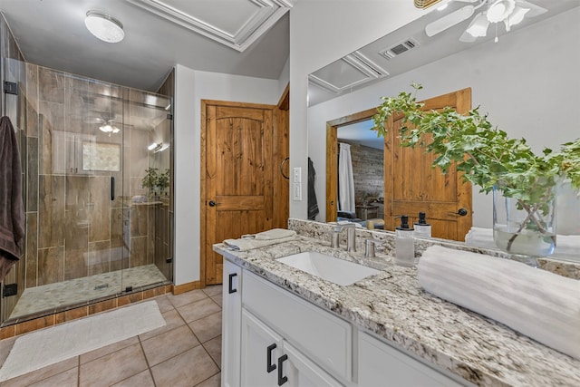 bathroom with vanity, tile patterned flooring, ceiling fan, and a shower with door