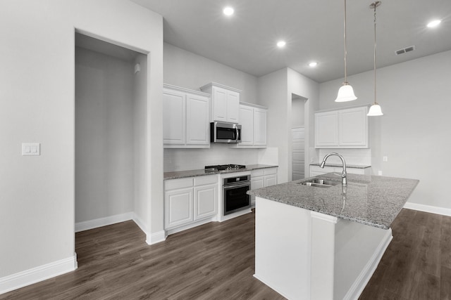 kitchen featuring sink, decorative light fixtures, white cabinetry, tasteful backsplash, and appliances with stainless steel finishes