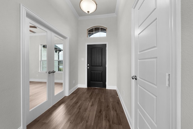 foyer featuring ornamental molding, dark wood-type flooring, and french doors