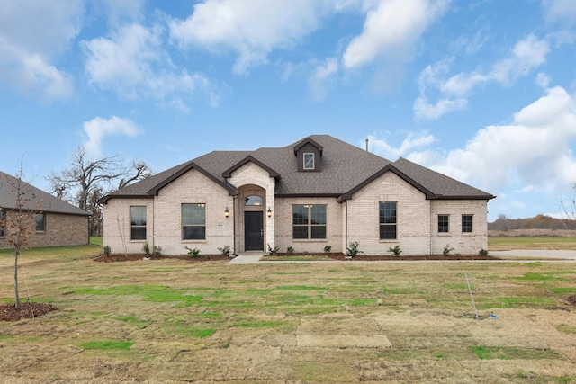 french country home with a front yard