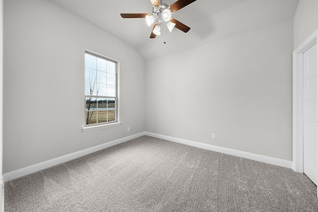 carpeted empty room with ceiling fan and vaulted ceiling