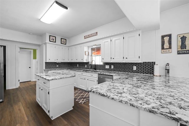 kitchen with kitchen peninsula, light stone counters, dark hardwood / wood-style flooring, and white cabinetry