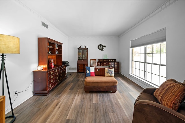 sitting room featuring crown molding and dark wood-type flooring