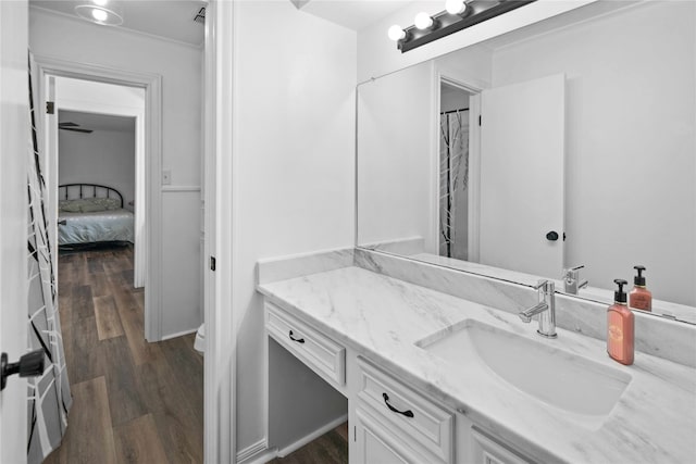 bathroom featuring vanity, toilet, and hardwood / wood-style flooring