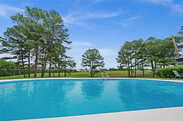 view of pool with a yard