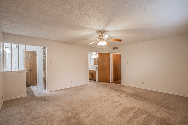 unfurnished room featuring ceiling fan, a textured ceiling, and carpet flooring