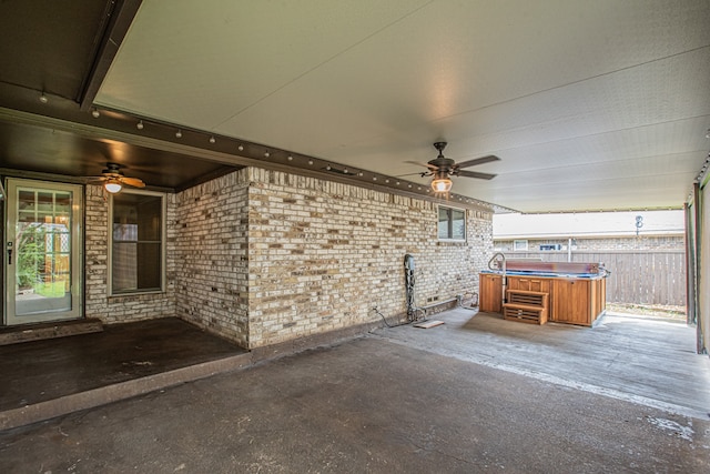 view of patio with a hot tub and ceiling fan