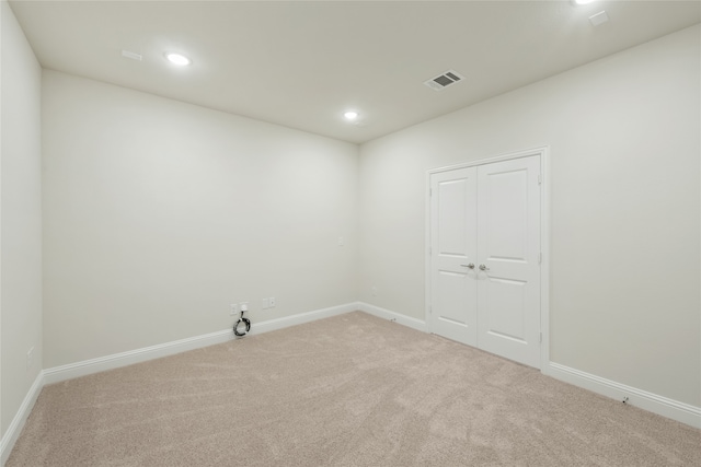 empty room with light colored carpet