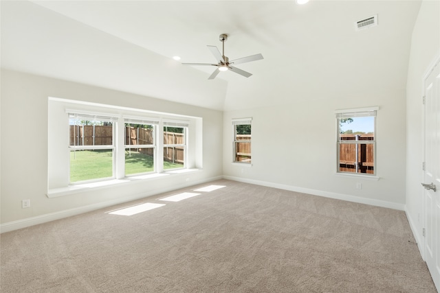 carpeted empty room featuring ceiling fan and high vaulted ceiling