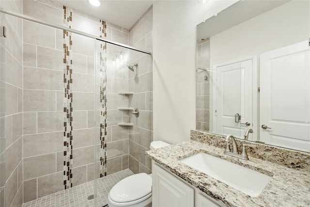 bathroom with vanity, toilet, and an enclosed shower