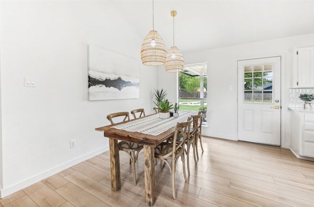 dining space with light wood-type flooring and a chandelier