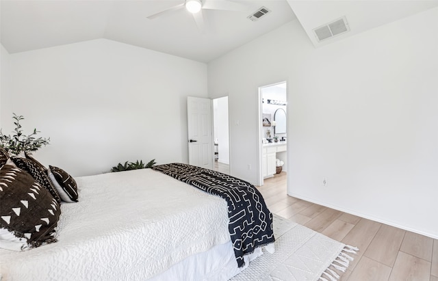 bedroom featuring ceiling fan, ensuite bathroom, vaulted ceiling, and light hardwood / wood-style floors