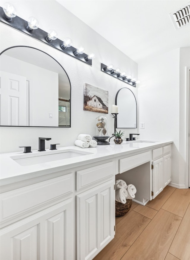 bathroom with vanity and wood-type flooring