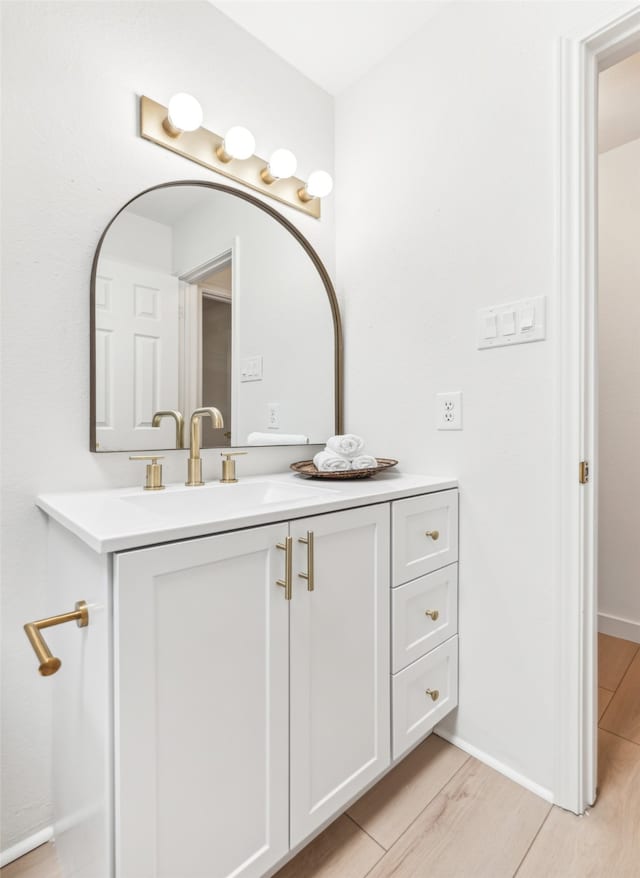 bathroom with vanity and hardwood / wood-style floors