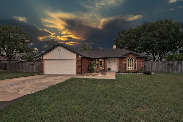 single story home with a garage and a lawn