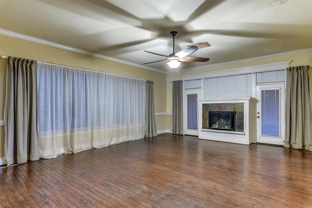 unfurnished living room featuring dark wood-type flooring, ceiling fan, a tile fireplace, and ornamental molding