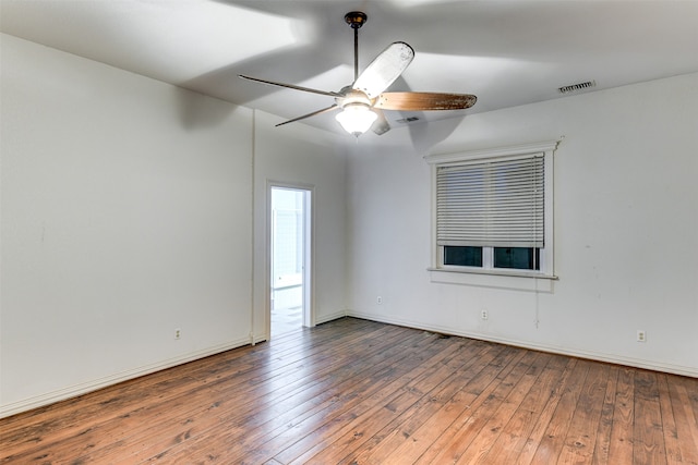 unfurnished room featuring ceiling fan and dark hardwood / wood-style flooring