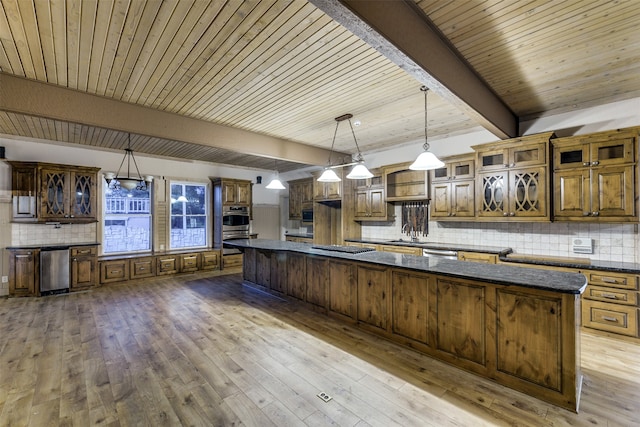 kitchen with wooden ceiling, a spacious island, wood-type flooring, and decorative light fixtures