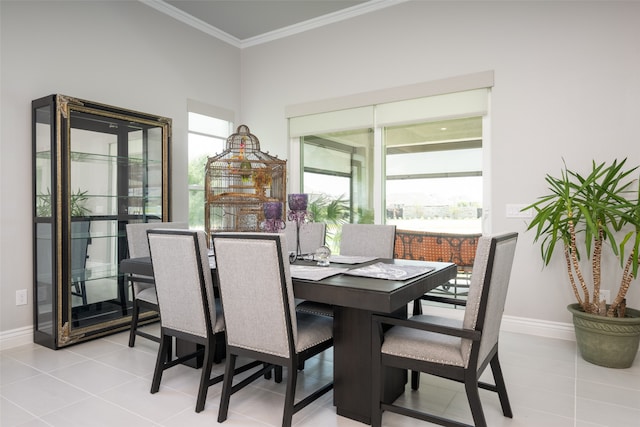 dining space featuring light tile patterned floors and crown molding