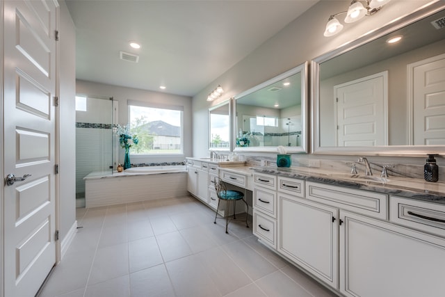 bathroom featuring vanity, shower with separate bathtub, and tile patterned floors