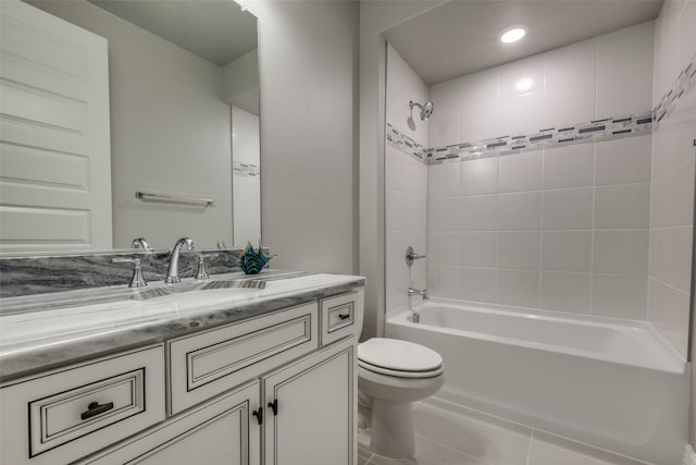 full bathroom featuring tile patterned flooring, vanity, toilet, and tiled shower / bath