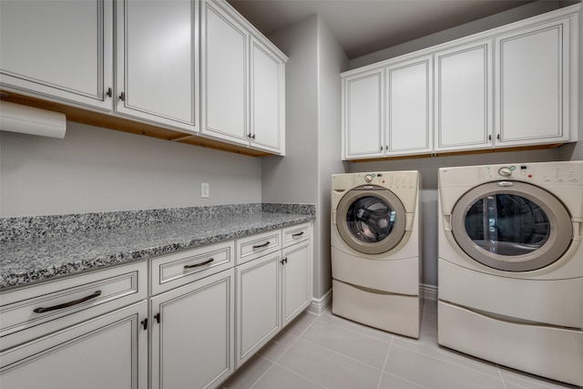 10008 Baywood Ct, Denton, TX 76207 - laundry area with cabinet space, washer and dryer, and light tile patterned flooring