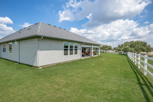 back of property featuring a patio area and a yard