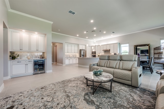 tiled living room featuring bar area, beverage cooler, and ornamental molding