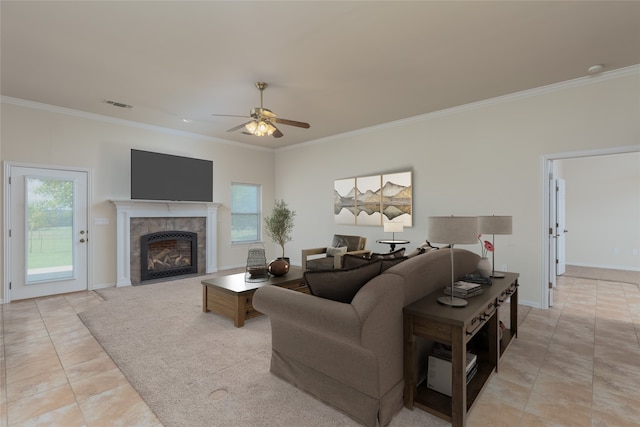 tiled living room featuring a tile fireplace, ceiling fan, and ornamental molding