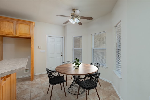 tiled dining room featuring ceiling fan