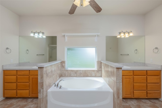 bathroom featuring tile patterned flooring, ceiling fan, separate shower and tub, and vanity