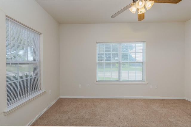 spare room featuring ceiling fan and light colored carpet