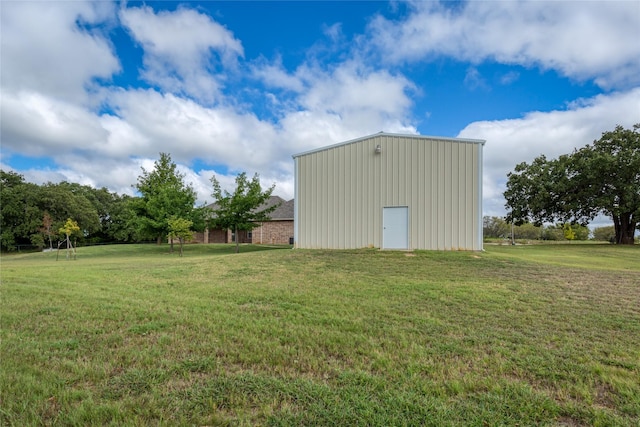 view of outbuilding featuring a lawn