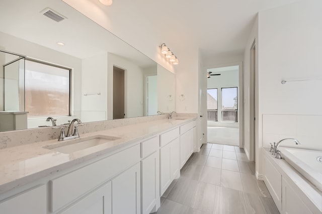 bathroom with vanity, a bathing tub, tile patterned flooring, and ceiling fan