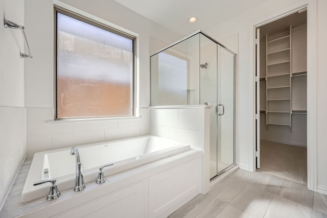 bathroom with separate shower and tub and tile patterned floors