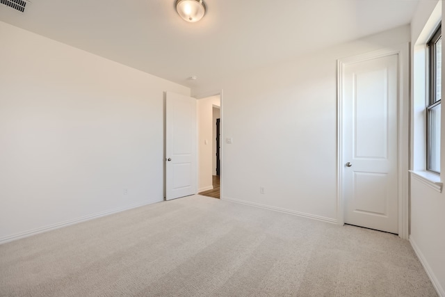 carpeted spare room with a healthy amount of sunlight