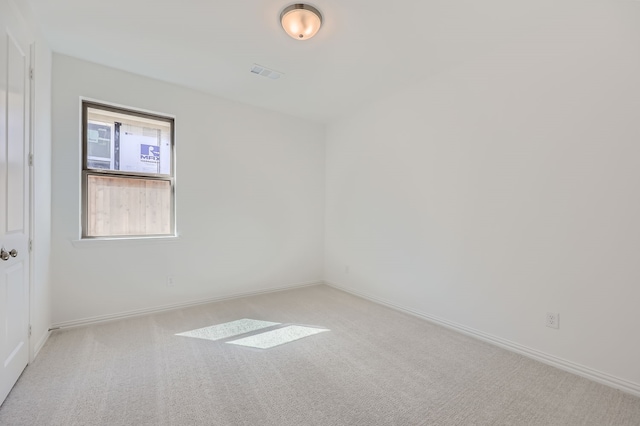 spare room with light colored carpet