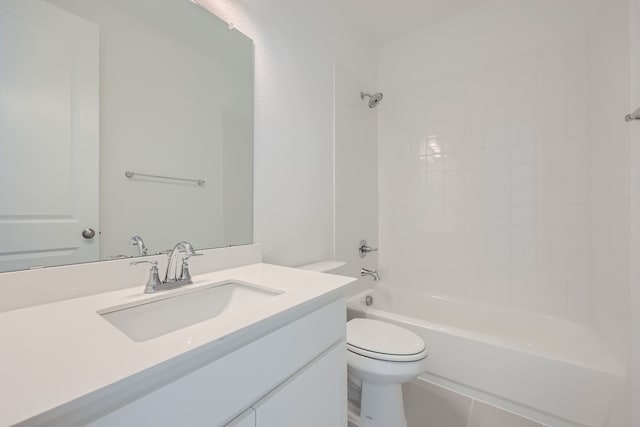 full bathroom with tiled shower / bath, vanity, and toilet