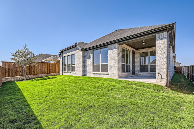 back of property featuring a yard and a patio