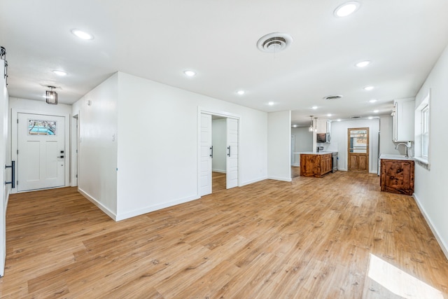 unfurnished living room featuring light hardwood / wood-style floors