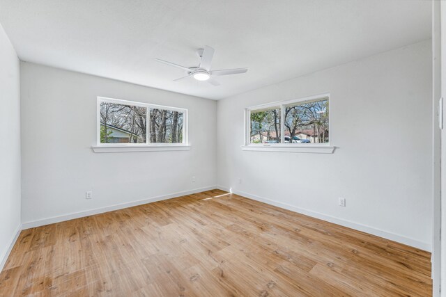 empty room featuring light wood-type flooring and ceiling fan